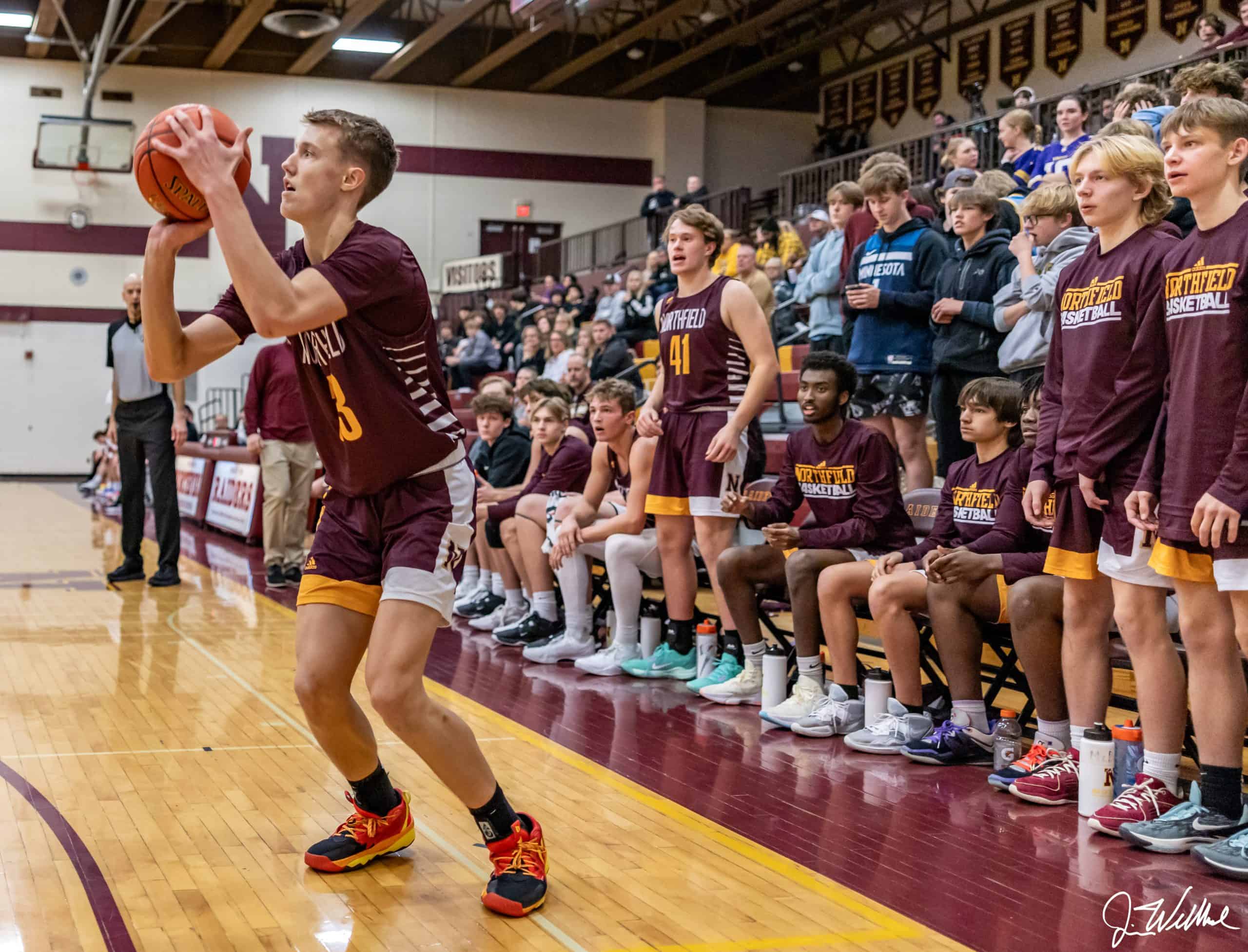 Isaiah Mahal lining up a three in Northfield's game vs Mankato East. photo by Jim Wellbrock